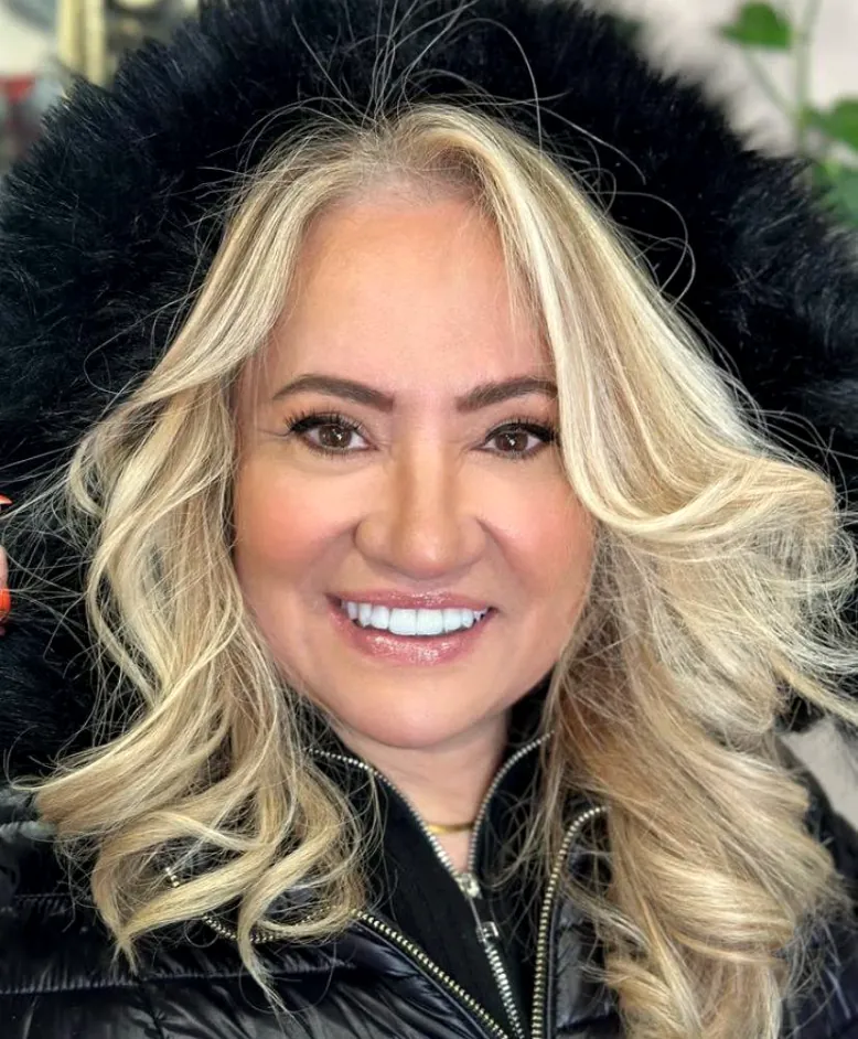 Cliente sorridente com loiro platinado e ondas